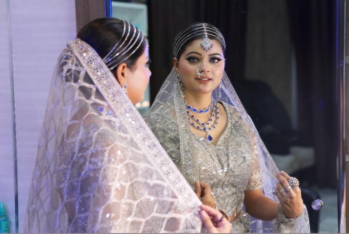 Bride at the mirror in silver and sapphire bridal jewellery