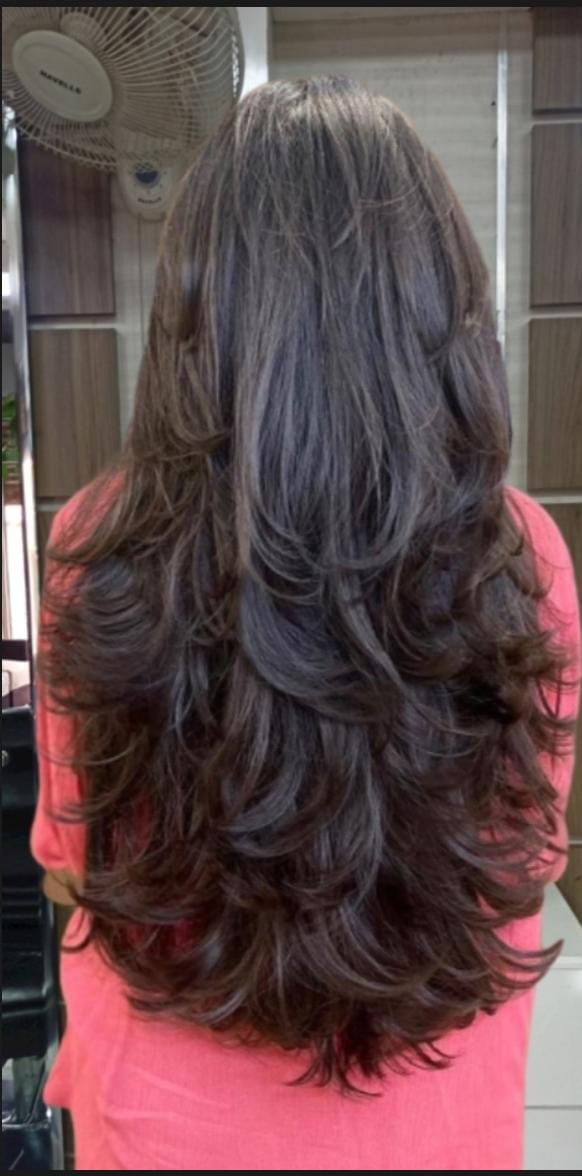 Long, layered hairstyling result viewed from behind